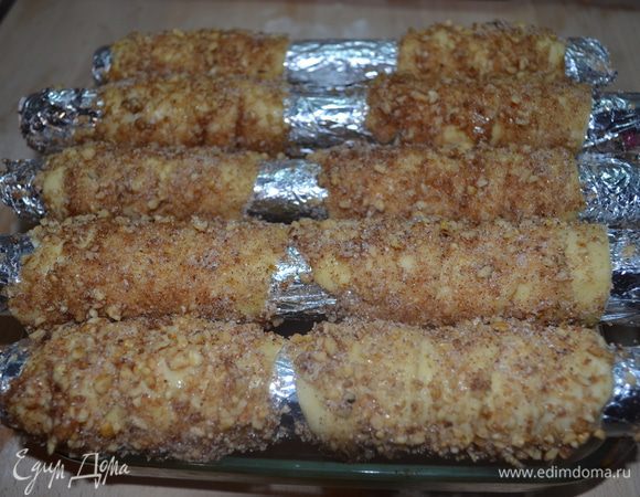 Немного сбиваем белок, смазываем со всех сторон тесто. Обильно обкатываем трубочки в смеси орехов, корицы и сахара.