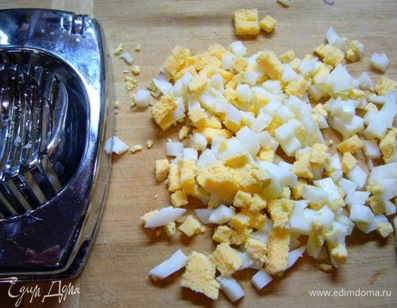 Кальмары почистить, опустить в соленую кипящую воду (соль – из расчета 1 ст. л. на 1 литр воды), варить 3 мин. Остудить. Порезать.
Яйца отварить 7 мин., остудить. Очистить от скорлупы. Нарезать кубиками. 
