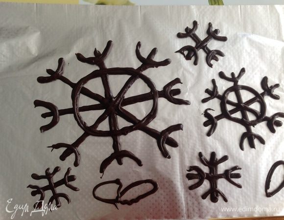 Тесто помещаем в кулинарный мешок, в моем случае в шприц с насадкой 0,5 мм и рисуем на пергаменте снежинки в количестве 10-12 штук. Каждая последующая должна быть меньше предыдущей.