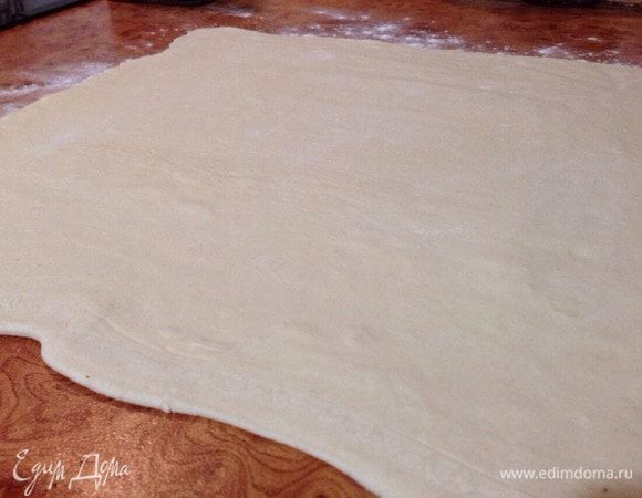 Слоеное тесто разморозить. Стол подпылить мукой, и раскатать тесто (в одном направлении), толщиной не более 3-4 мм.