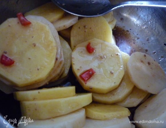 Картошечку (порции регулируем в соответствии с аппетитом едоков. для дам по одной, а для кавалеров...ну вы же знаете своих кавалеров))) моем, чистим (если молодая, то просто помоем), режем чипсинками примерно 3-5 мм, можно на комбайне. Теперь кружочки в маринад и перемешать. У меня стояли всего минут 20, но думаю, что подольше - получше. А тем временем замочить деревянные шпажки. Ну как замочить, у меня и емкости такой не нашлось. Я намочила их под краном и сунула в пакет полиэтиленовый.