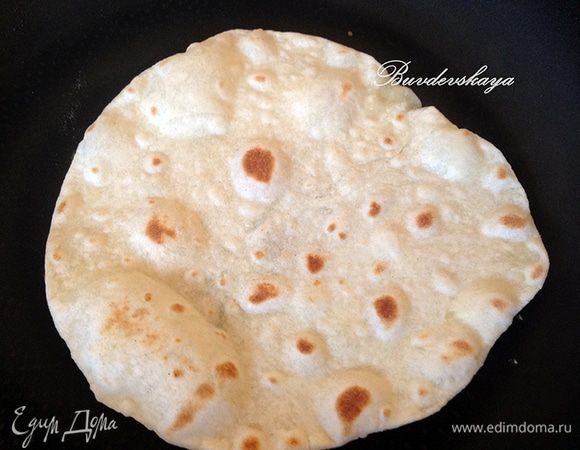 Обжарить лепешку на сухой разогретой сковороде с двух сторон по 1–2 минуты с каждой стороны.