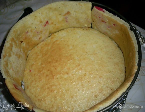 Из подготовленного теста для боковинок вырезаем полоски шириной с высоту формы. Выпеченный корж немного обрезаем, чтобы в кольцо формы поместился корж и боковинки. Их вставляем сердечками наружу. Собираем торт на блюде, на котором будете торт подавать, потому что потом его переместить будет очень сложно.