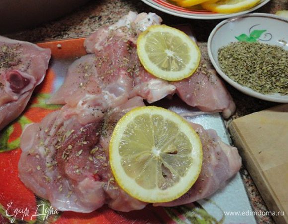 Оставшиеся 1,5 лимона нарезать тонкими кружочками. Каждую ножку цыпленка разрезать вдоль и развернуть (как книжку). Посолить, поперчить и посыпать смесью сухих трав орегано и майорана, взбрызнуть оливковым маслом. Положить по одному-два кружочка лимона