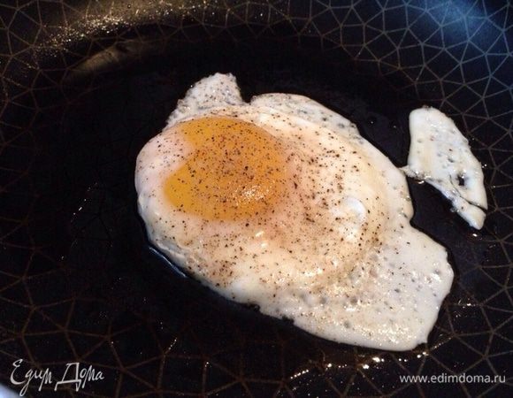 Тем временем поджарить яичницу-глазунью.