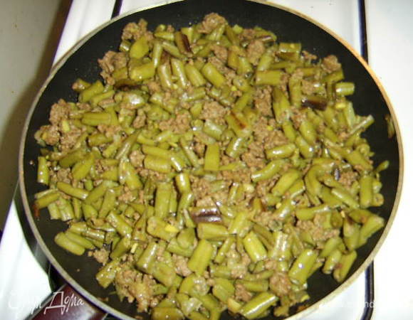 Стручковую фасоль нарезать длиной по 1 см, обжарить на растительном масле без запаха (2ст.л.) на сковороде в течении 5-10 мин, затем добавить немного воды и потушить до полуготовности.