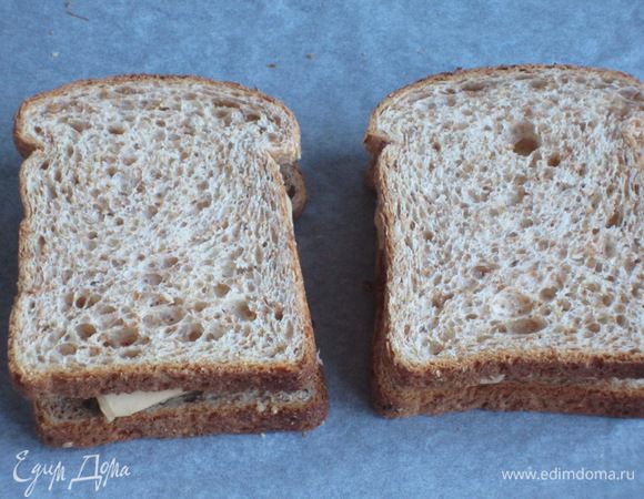 Сыр нарезать пластинками и выложить на начинку, накрыть вторыми половинками хлеба и запечь в духовке ещё 10 минут.