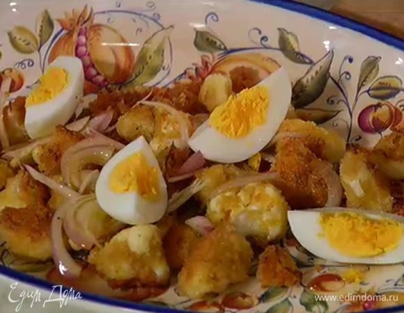 На большое блюдо выложить горячую обжаренную капусту, полить заправкой с луком, сверху выложить разрезанное яйцо.
