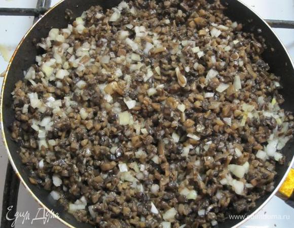 Грибы дадут воду. Когда вода выпарится, влить растительное масло и добавить мелко нарезанный лук.