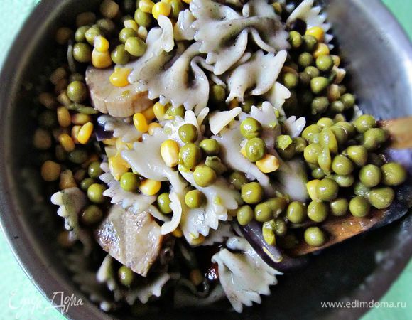 Воду из баночки с кукурузой и из баночки с горошком слить. Кукурузу и горошек добавить к пасте.