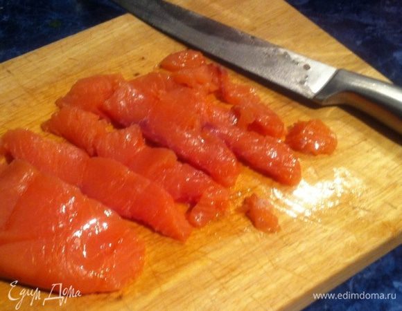 Нарезаем слабосоленую семгу на ломтики.