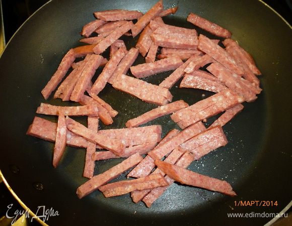 Колбасу нарезаем соломкой и обжариваем сковороде пару минут. Можно использовать либо вареную колбасу, либо копченую, тут по желанию. А лучше всего взять куриную грудку, обжарить целиком, а потом порезать. Но сегодня у меня грудки дома не оказалось...