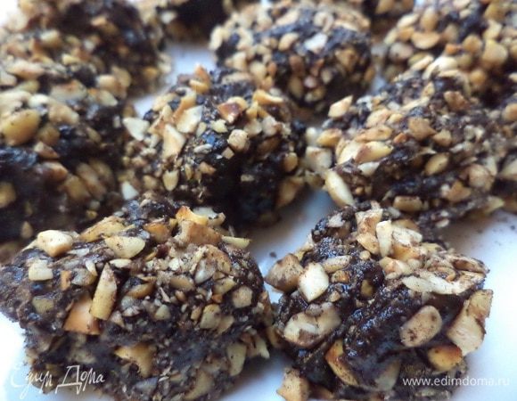 С помощью ложки, смоченной в холодной воде, сформировать из остывшей массы небольшие шарики.
Обвалять шарики сначала в какао, затем - в рубленых орехах. 
На 2 - 3 часа убрать в холодильник.