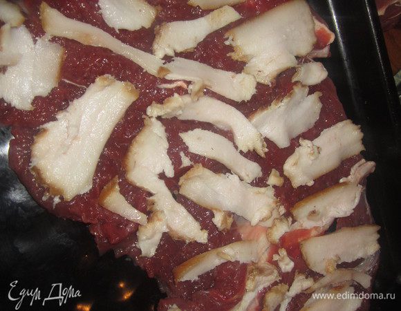 Шпик нарезать тонкими ломтиками, выложить на мясное филе ровным слоем.