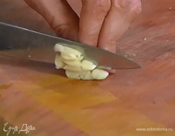 Чеснок почистить, раздавить плоской стороной ножа и мелко нарезать.