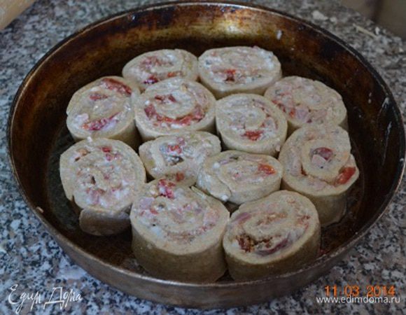 Круглую форму смазать маслом, выложить "улиток", плотненько друг к другу, смазать яйцом.