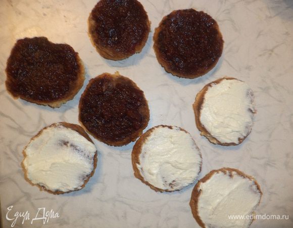 Половину остывших печенек намазать повидлом. А вторую половину печенек - масляным кремом. 
Соединить половинки с разной прослойкой, слегка прижать.