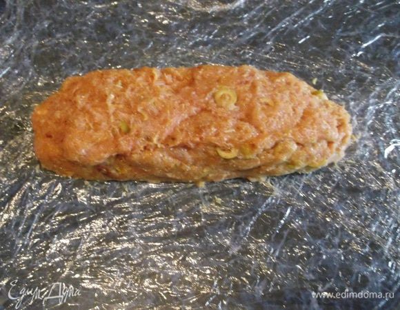 За это время нарезаем оливки и помидорчики. На самом деле, добавлять можно все, что душе угодно. В оригинале рецепта добавлялась отварная морковь и замороженный горошек. Добавляем в фарш и перемешиваем. На стол выкладываем пищевую пленку в два слоя, на нее-фарш