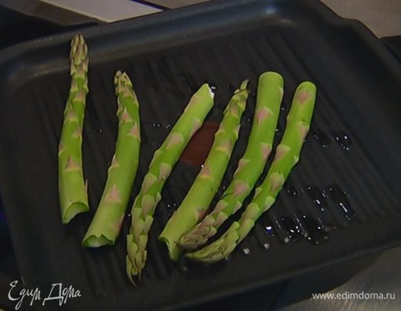 Разогреть в сковороде-гриль оливковое масло и обжарить спаржу с двух сторон, затем снять со сковороды.