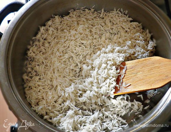В сковороде нагреть 2 ст л растительного масла. Слегка обжарить в нём рис постоянно помешивая до прозрачного состояния.  Затем залить рис горячей водой, покрывая его на 1 палец , посолить, приправить имбирём и варить при закрытой крышке до готовности риса. При необходимости, добавьте немного воды.