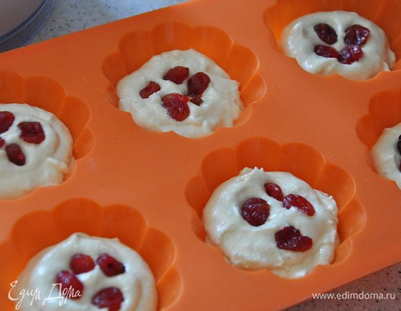 Формочки заполнить на треть тестом, выложить вишню и сверху залить тестом.