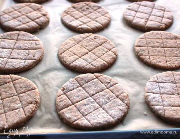 Сделать на поверхности неглубокие надрезы в виде решетки. Выложить хлебцы на противень, выстеленный бумагой.