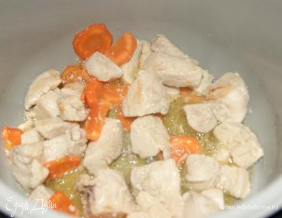 На режиме "Мультиповар" установить температуру 160 гр. В чашу налить оливковое масло, добавить половину сливочного масла, выложить курицу и морковь, посолить, обжарить 10 минут.