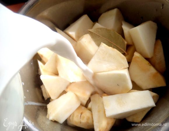 Выложить овощи в кастрюлю с солью и лаврушкой и залить молоком пополам с водой.