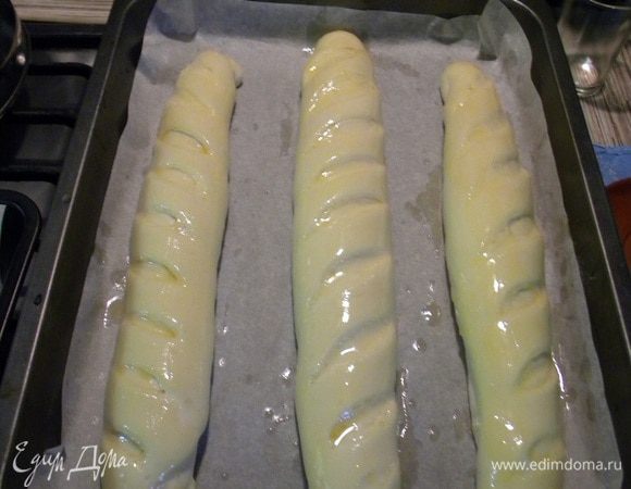 Оставляем на час, потом смазываем яичным желтком, делаем наше зеленое масло, мягкое масло смешиваем с зеленью, я беру зеленый чеснок или укроп с чесноком и измельчаем в блендере, готовый багет разрезаем в тех самых надрезах и ножом засовываем масло во все надрезы.