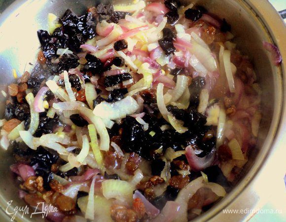 Добавить изюм и чернослив к луку и тушить под крышкой 5 минут.
