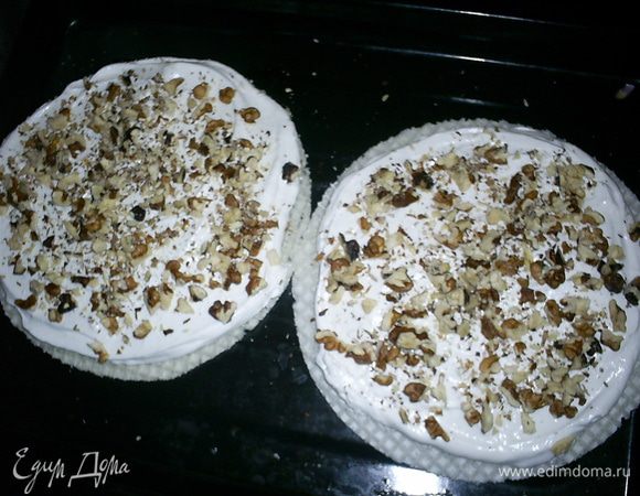 Теперь берем круглые вафельные коржи. У меня было 4 штуки диаметром 19см. Можно взять три коржа диаметром 23-24см. Равномерно распределяем по коржам белковую массу. Посыпаем грубо нарубленными орехами (стакан - 250мл). Их предварительно обжаривать не надо. Они прокалятся в духовке.