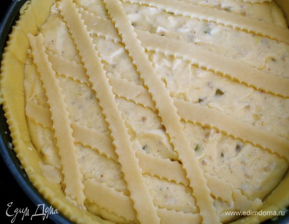 Наподобие кростаты выложить поверх крема полоски нарезанного теста. Сначала несколько полосок в одном направлении..., немного под углом... А затем сверху второй ряд полосок из теста, снова слегка под углом.