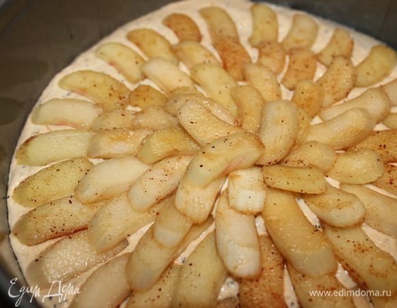 Получившееся тесто выливаем в форму, застеленную пергаментом. Бортики желательно смазать маслом. Сверху выкладываем кусочки ревеня.