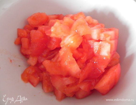 Пока баклажаны запекаются, ошпарьте помидоры, снимите с них кожицу, мякоть мелко нарежьте.