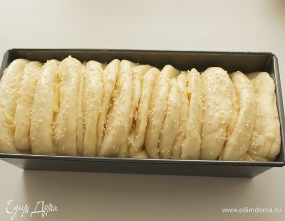 Через час смажьте яйцом и посыпьте кунжутом.