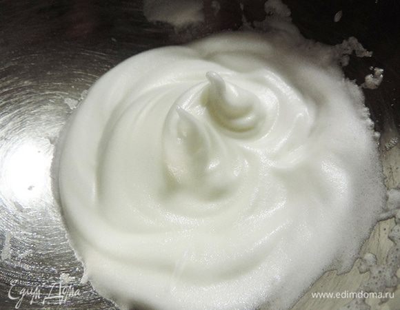 Охлажденные белки взбиваем до состояния, когда пики уже появляются и становятся устойчивыми, но белки выпадают из емкости при ее переворачивании. Взбитые белки отправляем в холодильник.