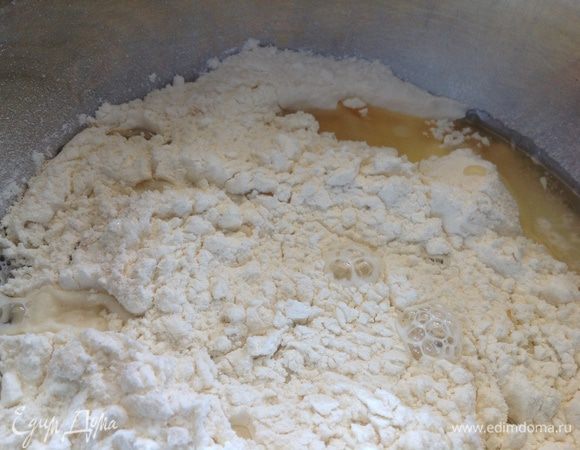В муку добавим тёплую воду и растительное масло.
