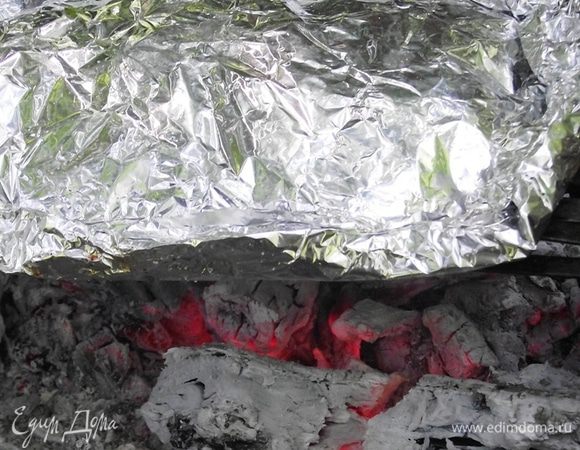 Плотно закройте карман и оставьте на 20 минут. Тем временем готовим угли. Они должны хорошо прогреться. Ставим сетку прямо на угли и отправляем на нее картофель. Так он не будет гореть, а будет запекаться.