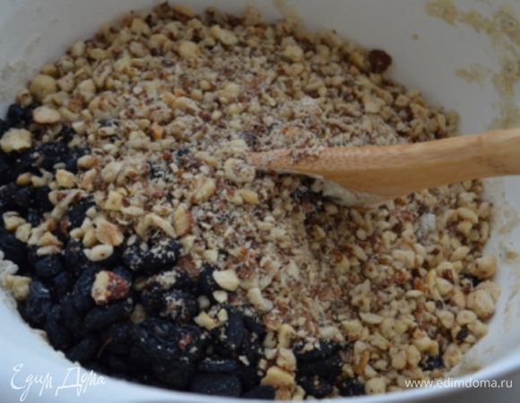 В тесто добавить изюм и орехи и вмешать их руками.