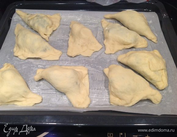 Сформировать треугольнички. Противень застелить бумагой для выпечки, смазать сливочным маслом. Выложить слойки, поставить в теплое место для расстойки на 20 минут.