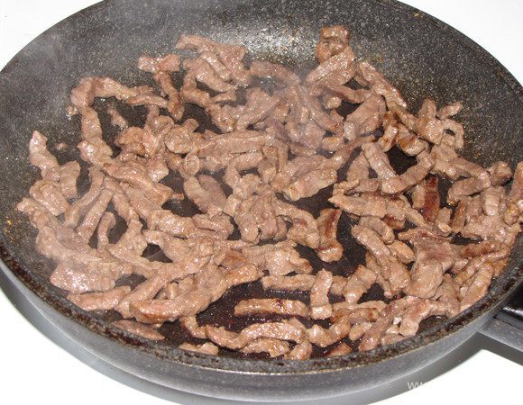 Разогреть в сковороде половину растительного масла и обжарить мясо в течении 5 минут. В конце посолить и поперчить по вкусу. Выложить мясо на бумажное полотенце, чтобы удалить лишний жир.