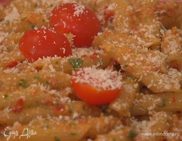 Макароны с песто выложить на тарелку, сверху разложить помидоры, посыпать натертым пармезаном и украсить листьями базилика.