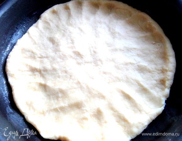 Разминаем по смазанной маслом форме 22 см,оставив немного на края и сетку.