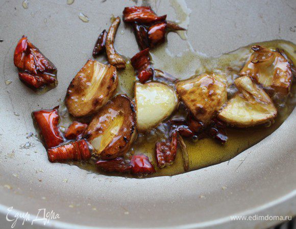 Чеснок и перец нарубить не очень мелко и обжарить на разогретом растительном масле (с добавлением кунжутного) в течение 1 минуты.