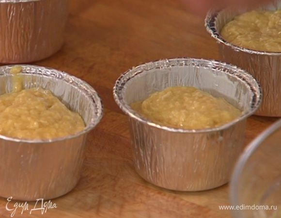 Небольшие формы из фольги смазать оставшимся сливочным маслом, заполнить тестом на 3/4 объема и поместить на противень.