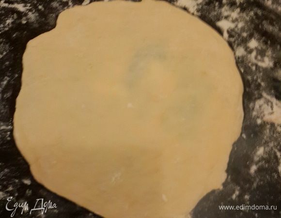 Начинаем раскатывать лепешку. Тесто у меня было липкое. Я припудрила мукой поверхность и руками сформировала тонкую лепешку.