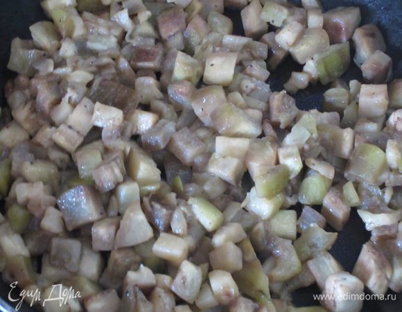 Разогреть в сковороде 4 ст.л. оливкового масла и обжарить зубчик чеснока.Чеснок удалить,добавить баклажаны и обжарить на сильном огне несколько минут. Посолить,поперчить,накрыть крышкой и готовить 15 минут на слабом огне до мягкости.Остудить.