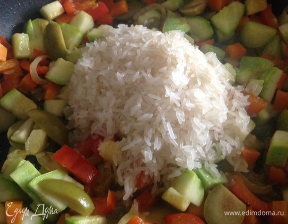 Промять рис. Добавить его к овощам и влить 300 мл. воды. 