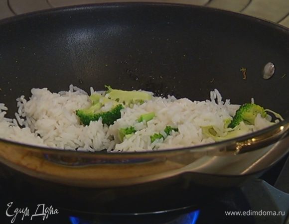 Разогреть в воке 1 ст. ложку оливкового масла и кунжутное масло, выложить брокколи, дать соцветиям пропитаться маслом, затем добавить готовый рис и все перемешать.