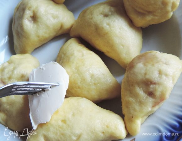 Готовые вареники я складываю в тарелку и сразу же смазываю сливочным маслом, накалывая его кусочек на вилку.